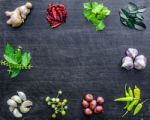 Top View Of Food Ingredients And Condiment On The Table, Ingredients And Seasoning On Dark Wooden Floor Stock Photo