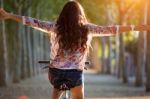 Pretty Young Girl Riding Bike In A Forest Stock Photo