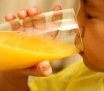 Boy Drinking Orange Juice Stock Photo