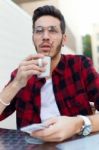 Confident Entrepreneur Drinking Coffee Focused In Something Stock Photo