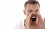 Young Fellow Shouting Loudly Stock Photo