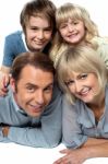 Parents Lying Down With Children On Top Stock Photo