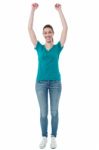 Excited Woman Raising Her Arms Up Stock Photo