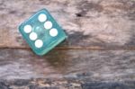 One Dice On Wooden Background Stock Photo