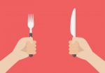 Knife And Fork Cutlery In Hands Stock Photo
