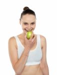 Woman Eating Green Apple Stock Photo