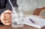 Woman's Hand Holding A Cold Glass Of Water Stock Photo