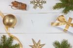 Golden Christmas Decoration On White Wood Background Stock Photo