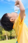 Little Asian Boy Drinking Water From Plastic Bottle Stock Photo