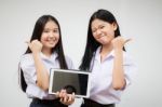 Two Asia Thai High School Student Uniform Best Friends Beautiful Girl Using Her Tablet And Funny Stock Photo