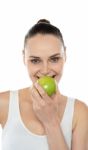 Woman Eating Green Apple Stock Photo