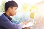 Asian Teenager Using Laptop  Stock Photo