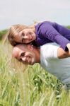 Man Giving His Wife A Piggyback Ride Stock Photo