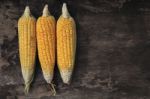 Yellow Corn On Wood Background Stock Photo