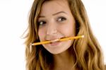 Caucasian Girl Biting Pencil Stock Photo