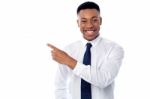 Smiling Businessman Pointing Away Stock Photo