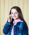 Girl In A Blue Denim Jacket Talking On A Phone Stock Photo