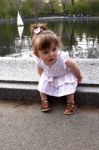 Happy Baby Sitting On Stone Ledge Stock Photo