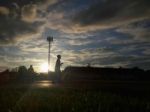 Silhouette  Running On Road At Sunrise Stock Photo