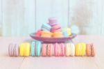 French Macarons On Pink Wooden Background. Vintage Style Stock Photo