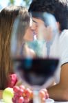 Attractive Couple Kissing Wine On Romantic Picnic In Countryside Stock Photo