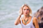 Beautiful Young Blonde Woman Posing Outdoor At The Rocky Sea Sho Stock Photo