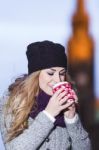 Attractive Young Stylish Blonde Girl Drinks Hot Drink From A Mug Stock Photo