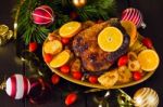 Christmas Baked Duck Served With Potatoes, Orange And Tomatoes Stock Photo