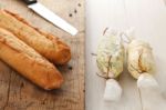 Baguette With Herb Butter And Rosemary Thyme On Rustic Wooden Background Stock Photo