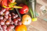 Fruits And A Bottle On A Wooden Stock Photo