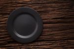 Black Empty Plate On Wooden Table Background Still Life Stock Photo