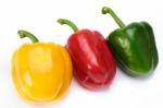 Red Green And Yellow Sweet Peppers On White Background Stock Photo