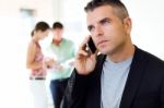 Businessman Talking On Mobile Phone In Office Stock Photo