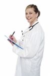 Female Doctor Writing Clipboard Stock Photo