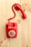 Red Landline Earphone And Cable On Wood Background Stock Photo