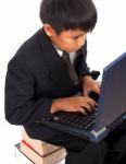 Boy Sitting On A Pile Of Books Stock Photo