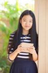 Twelve Years Old Asian Kid Standing With Happiness Smiling Face And Tablet Computer In Hand Use For Modern Life Of Education And Livestyle Stock Photo