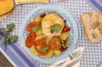 Fish With Potatoes And Tomato Stock Photo