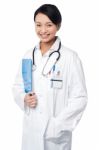 Young Doctor Holding Clipboard Stock Photo