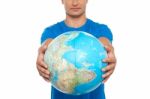 Young Male Holding Globe Stock Photo