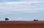 Tractor Plowing On Field Stock Photo