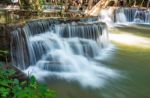 The Water Flowing Over Rocks And Trees Down A Waterfall At Huay Mae Khamin Waterfall National Park ,kanchana Buri In Thailand Stock Photo