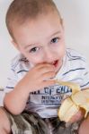 Little Boy Holding Peeled Banana Stock Photo