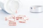 Closeup Of Pink Pills And Pill Bottle Stock Photo