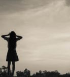 Silhouette Of Woman Praying Over Beautiful Sky Background Stock Photo