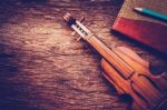 Violin And Notebook With Pencil On Grunge Dark Wood Background Stock Photo