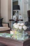 Glass Vase Of Flower On Wooden Table In Living Room Stock Photo