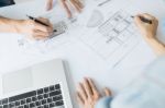 Architects Engineer Discussing At The Table With Blueprint - Clo Stock Photo