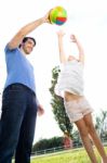 Happy Young Family, Father And Son Playing Ball In The Park Stock Photo