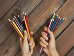 Set Of Colored Pencils In Female Hands On A Background Of Dark W Stock Photo